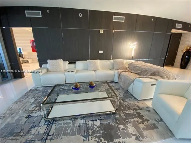 a living room with a couch and a rug