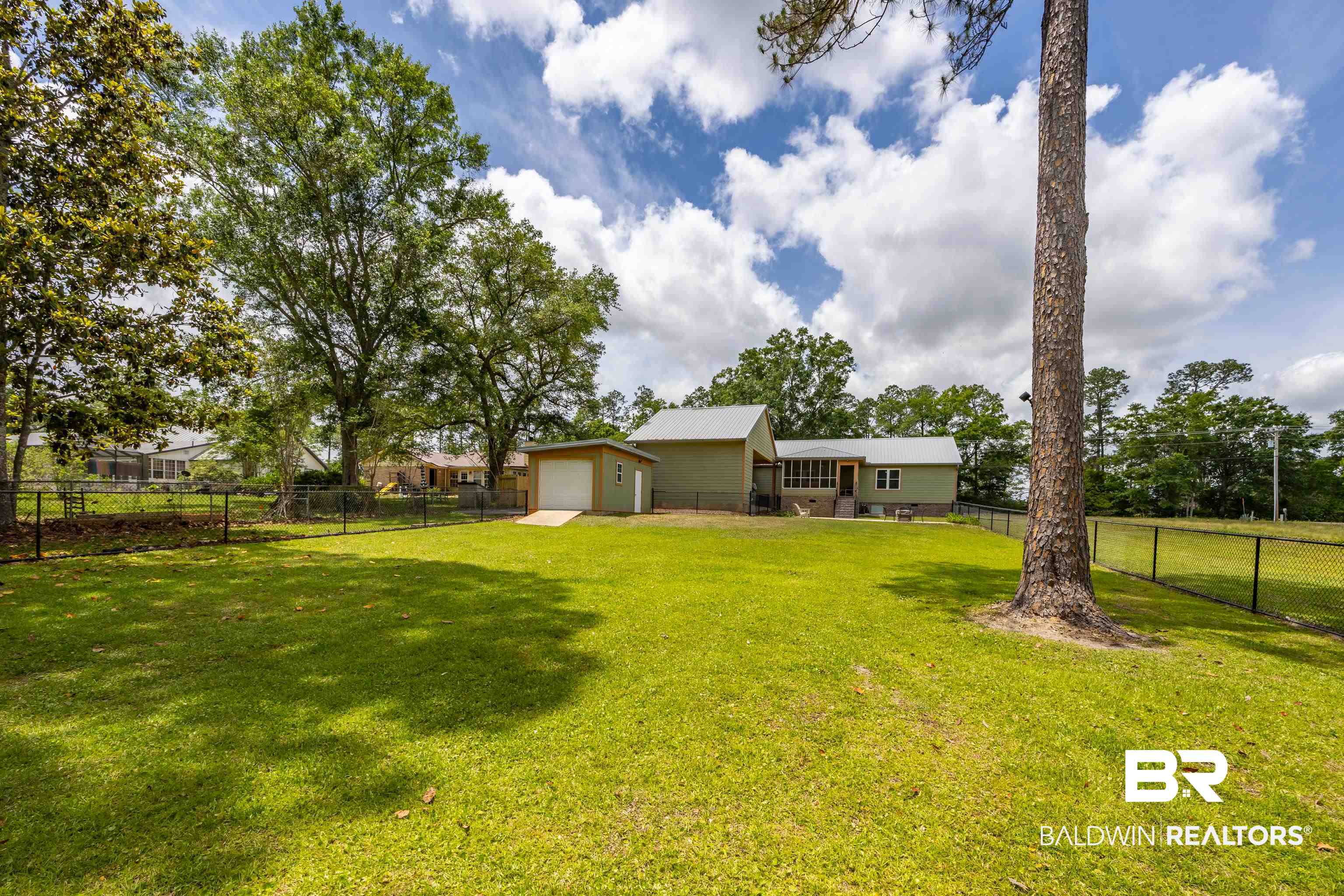 9771 Clarke Ridge Road Foley, AL 36535 - Photo 5 of 72 View of yard with a fenced backyard and a detached garage