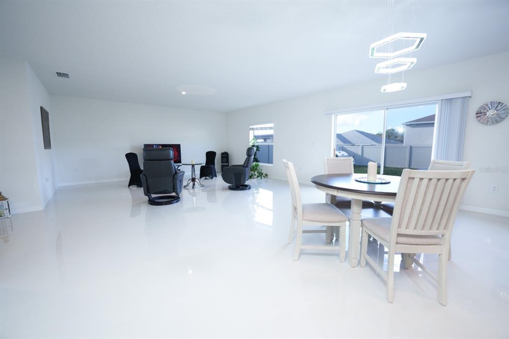 458 Hamlet Loop Davenport, FL 33837 - Photo 2 of 19 a dining room with furniture and wooden floor