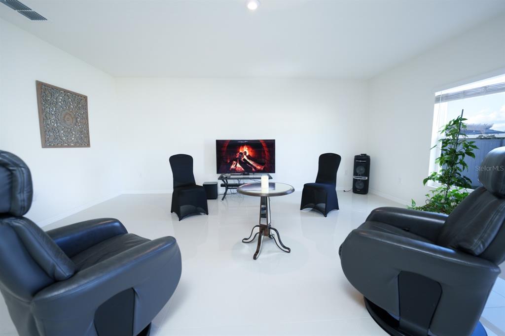 458 Hamlet Loop Davenport, FL 33837 - Photo 3 of 19 a living room with furniture and a flat screen tv