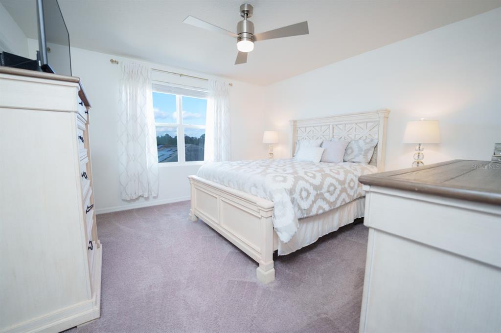 458 Hamlet Loop Davenport, FL 33837 - Photo 5 of 19 a bedroom with a bed dresser and a window