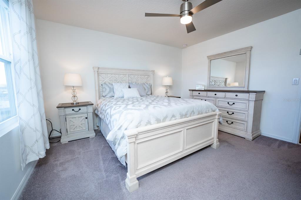 458 Hamlet Loop Davenport, FL 33837 - Photo 6 of 19 a bedroom with a bed and a dresser