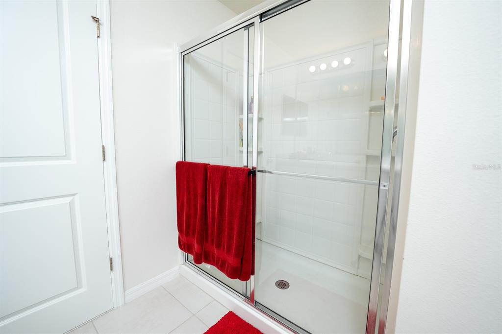 458 Hamlet Loop Davenport, FL 33837 - Photo 7 of 19 a bathroom with a shower and a mirror