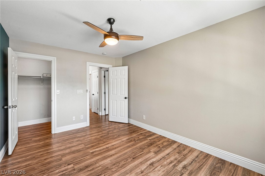 1176 Butternut Ranch Court Henderson, NV 89052 - Photo 24 of 60 Well-lit room with wood plank flooring provides a neutral palette for personalized decor.