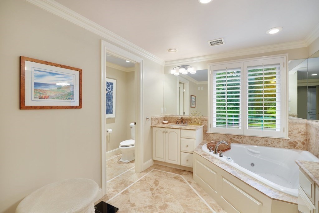 37 Autumn Road Weston, MA 02493 - Photo 20 of 42 a bathroom with a granite countertop tub a toilet a sink and a large window
