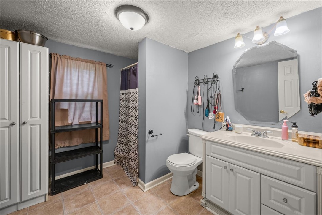 668 Marcengill Road Westminster, SC 29693 - Photo 31 of 37 Functional full bathroom featuring a white vanity with ample storage and a tiled floor.