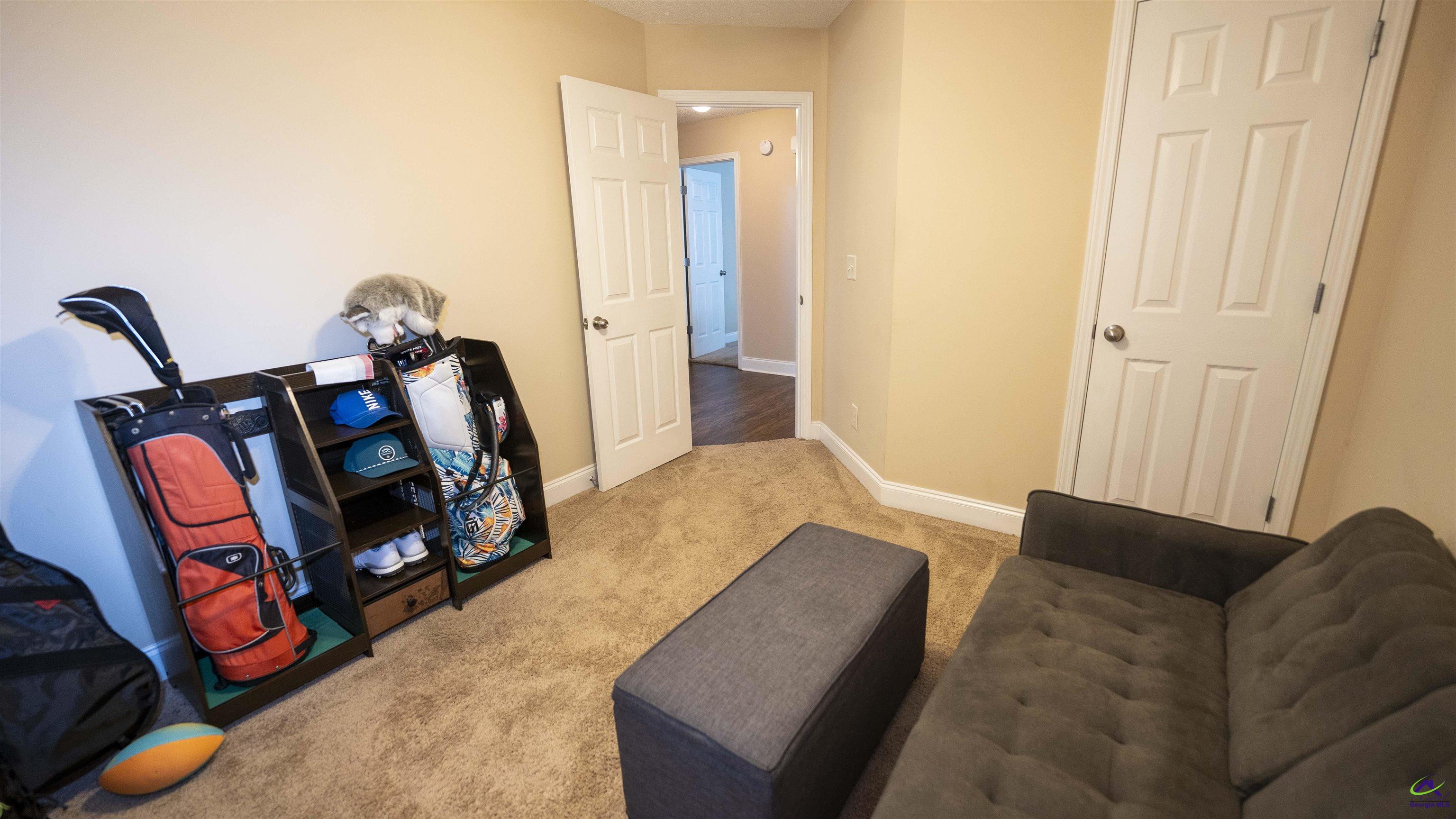 311 Sugarloaf Parkway Perry, GA 31069 - Photo 21 of 31 a bedroom with a bed and wooden floor