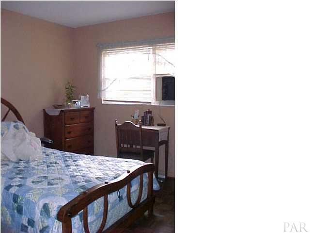 6415 Hampton Road Pensacola, FL 32505 - Photo 6 of 11 a dining room with a table and chairs