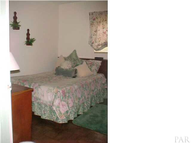 6415 Hampton Road Pensacola, FL 32505 - Photo 9 of 11 a bedroom with a bed and a painting on the wall