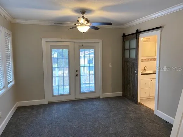 an empty room with windows and closet