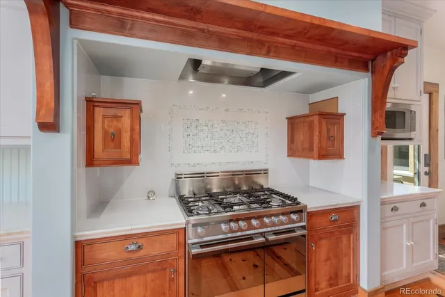 a kitchen with stainless steel appliances granite countertop a stove and a microwave