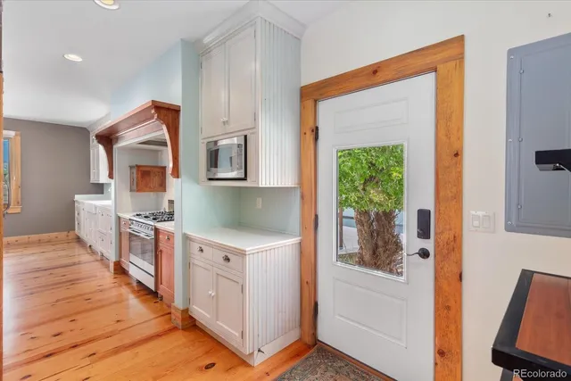 a kitchen with a cabinets and wooden floor