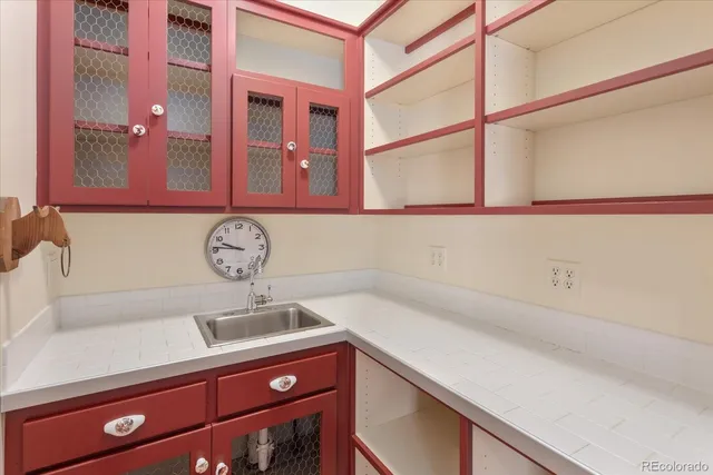 a view of a storage and utility room with a sink