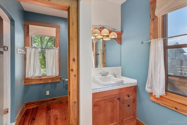 a bathroom with a sink a mirror and a window