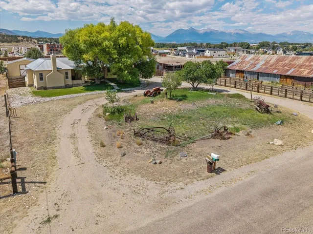an aerial view of a house with a yard basket ball court and outdoor seating