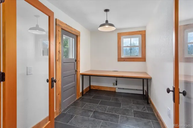 a view of hall way with mirror and furniture