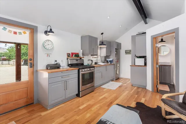 a kitchen that has a lot of cabinets a sink and appliances in it