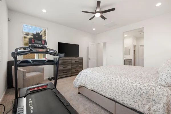 a kitchen with stainless steel appliances granite countertop a dining table chairs refrigerator and sink