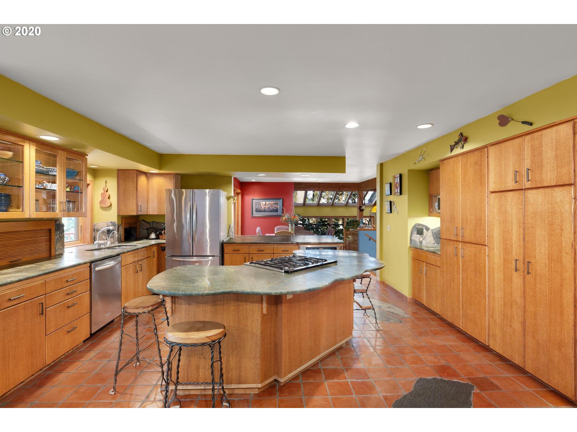 2654 Southwest Fairmount Boulevard Portland, OR 97239 - Photo 3 of 32 a kitchen with stainless steel appliances granite countertop a sink and a refrigerator
