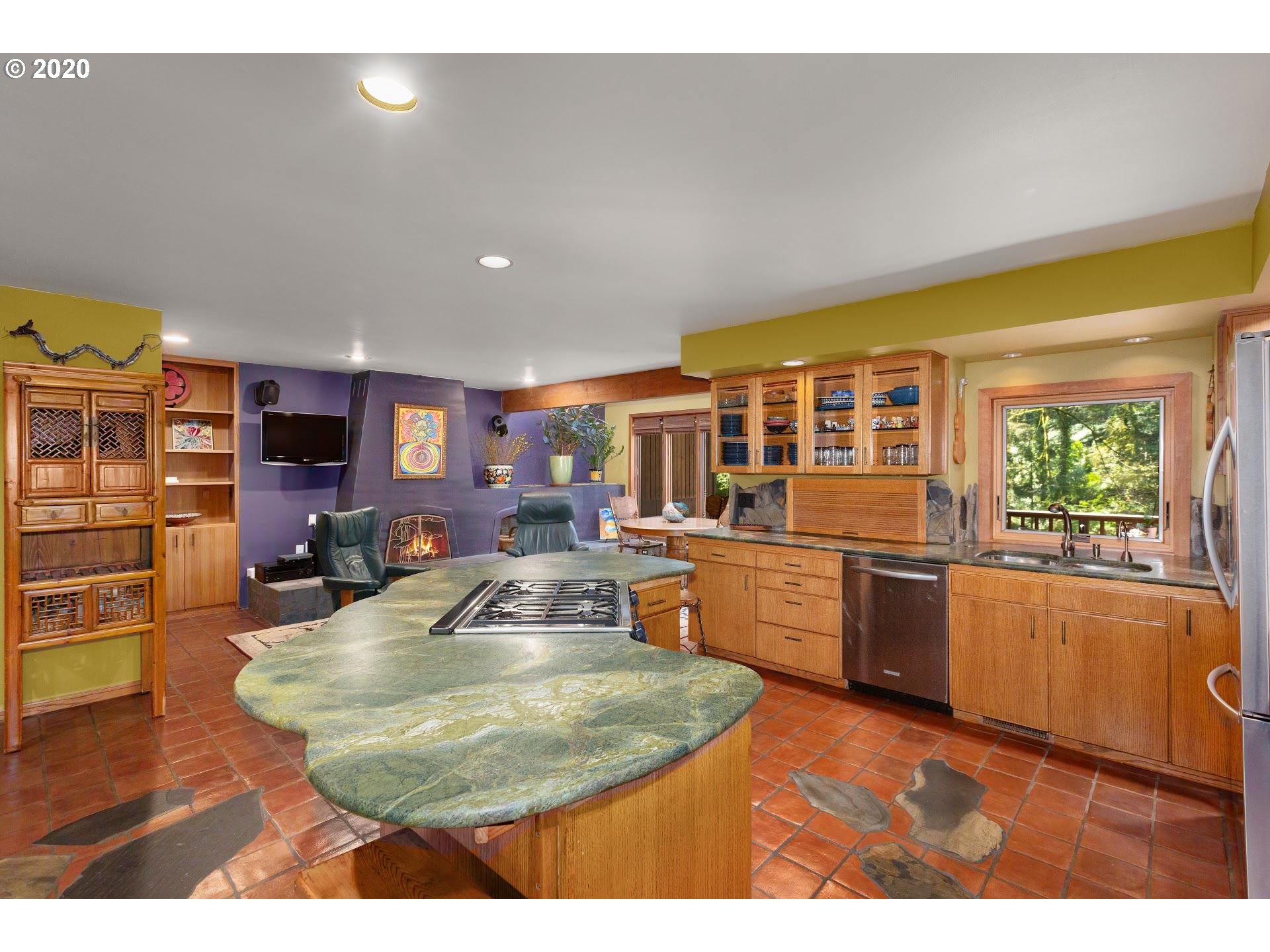 2654 Southwest Fairmount Boulevard Portland, OR 97239 - Photo 4 of 32 a kitchen with stainless steel appliances granite countertop a sink counter space and a large window