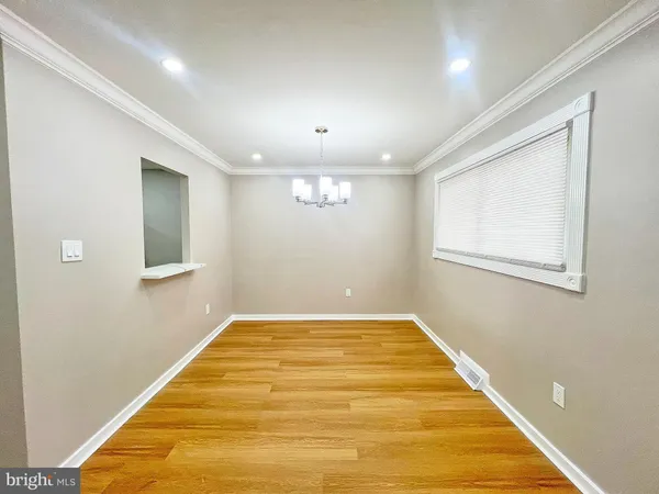 a bedroom with a bed and a wooden floor