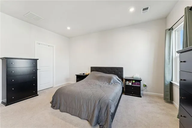 a bedroom with a bed and a closet