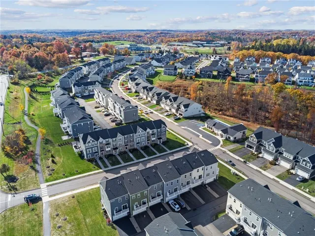 an aerial view of residential houses with outdoor space