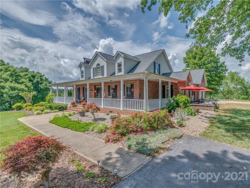 631 Pleasant Hill Church Road Rutherfordton, NC 28139 - Photo 3 of 48 a front view of a house with garden and porch