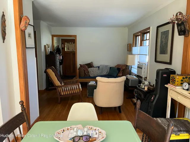 a living room with furniture a rug and a window