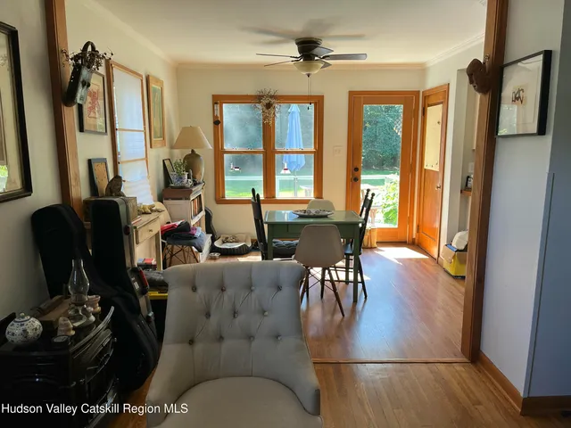 a view of a dining room with furniture window and wooden floor