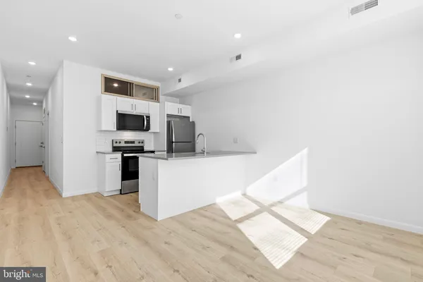 a view of kitchen with microwave and cabinets
