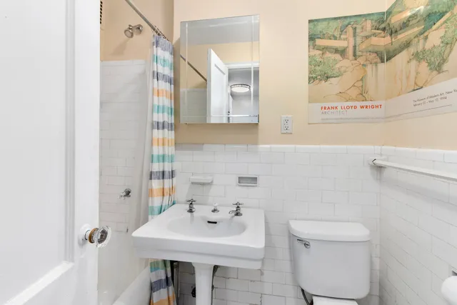 a kitchen with stainless steel appliances a dining table chairs refrigerator and sink