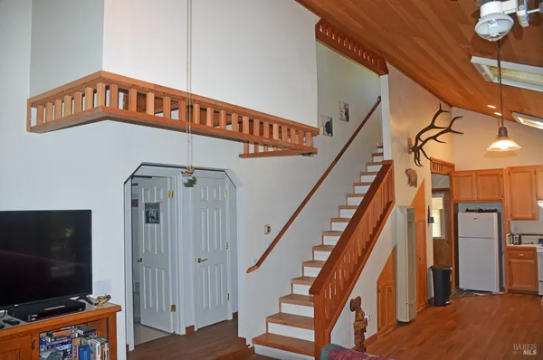 a view of an entryway with a flat screen tv