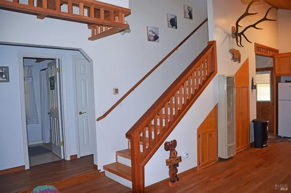 a view of entryway with wooden floor and stairs