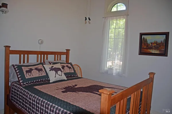 a bedroom with a bed and window