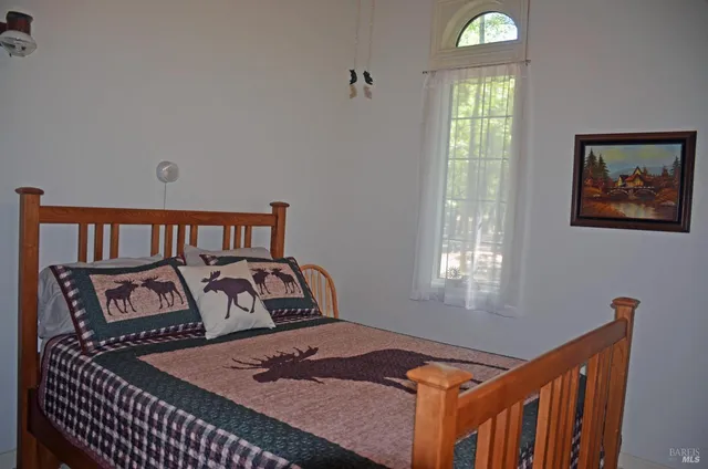 a bedroom with a bed and window