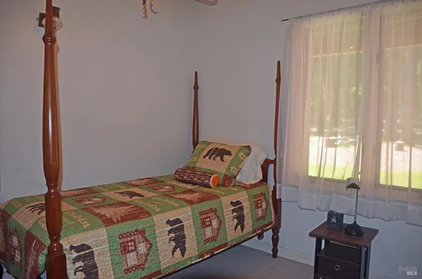 a bed sitting in a bedroom next to a window