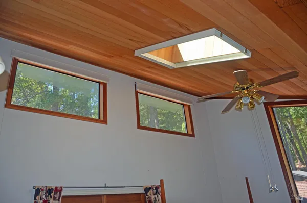 a view of room with window and a ceiling fan