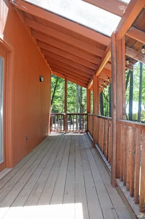 a view of backyard with wooden deck and floor