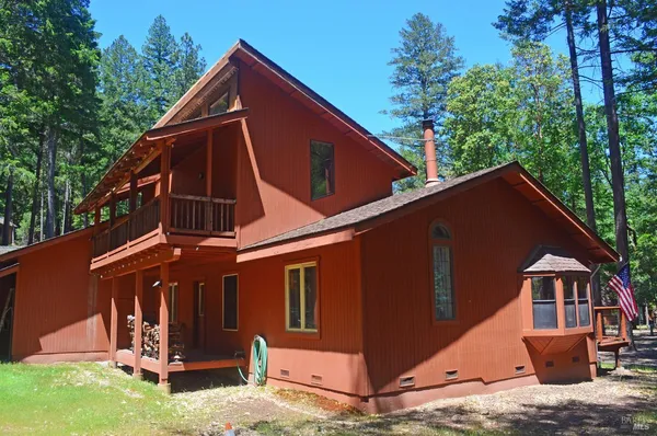 a backyard of a house with wooden fence and deck