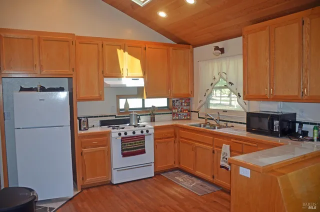 a kitchen with a stove a sink and a refrigerator
