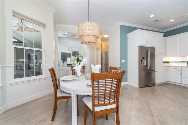 a kitchen with white cabinets appliances and a sink