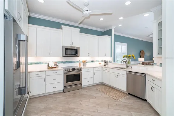 a kitchen with a sink and chairs