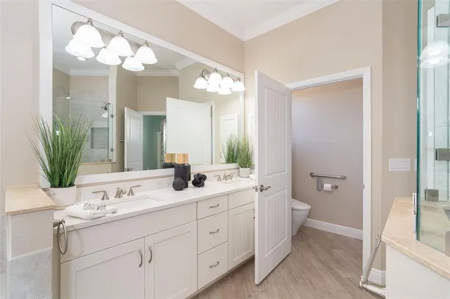 a bathroom with a double vanity sink mirror and shower
