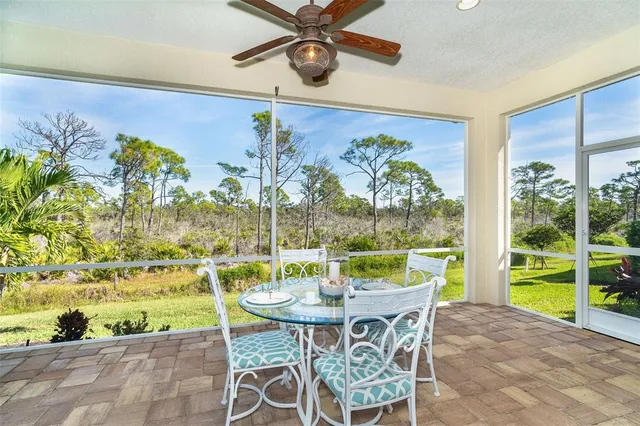 a view of a porch with chairs and backyard