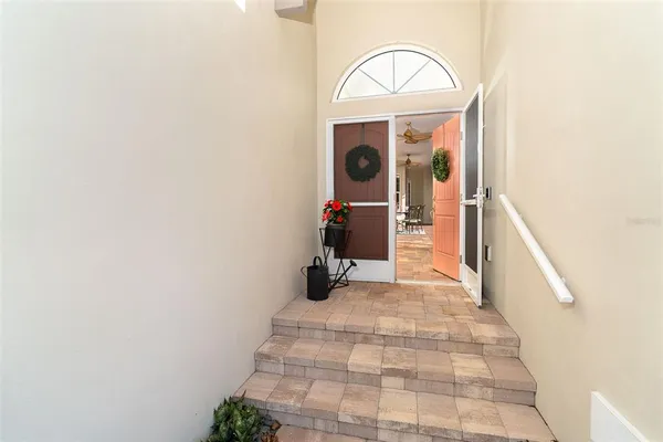 a view of a hallway with wooden floor and entryway