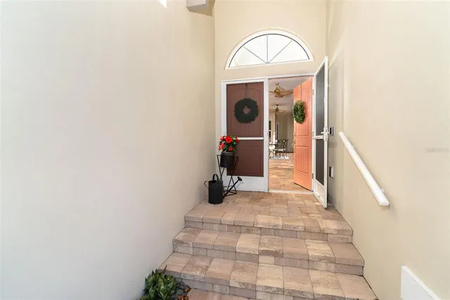 a view of a hallway with wooden floor and entryway