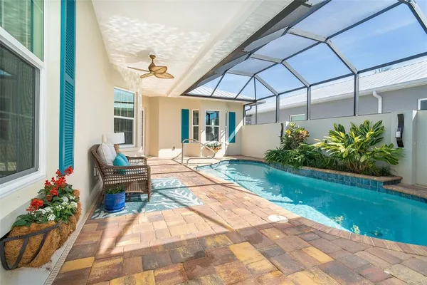 a view of a house with swimming pool and sitting area
