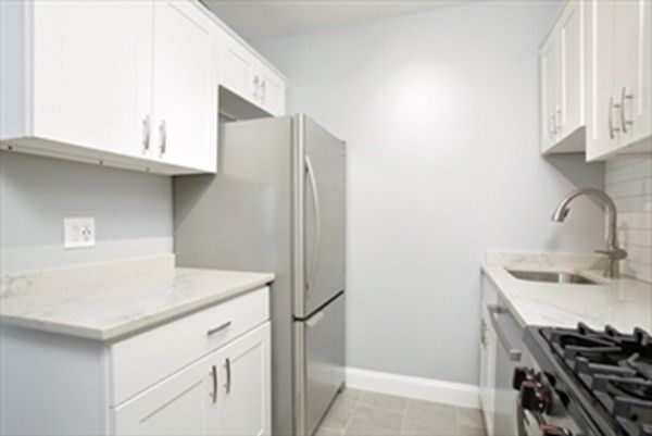 a kitchen with stainless steel appliances cabinets and a sink