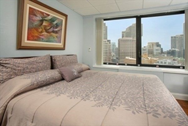 a large bedroom with a large bed and a large window